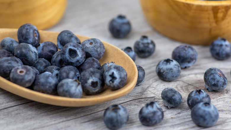 blueberries in wooden bowl and spoon