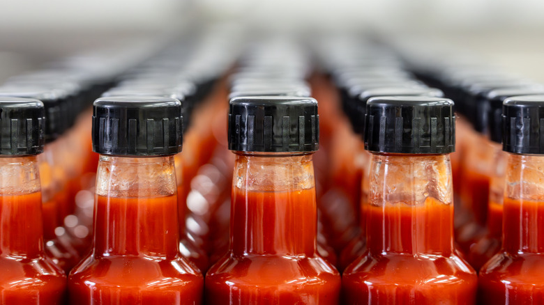 Rows of bottled hot sauce stacked against each other.