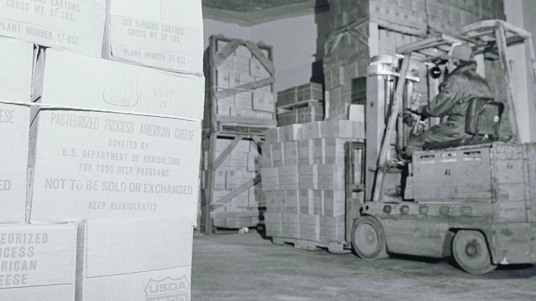 Man driving forklift in USDA government cheese storage facility