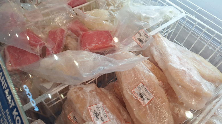 Frozen seafood that has been packed in plastic and stored in the freezer, including tuna and white fish fillets, among others.