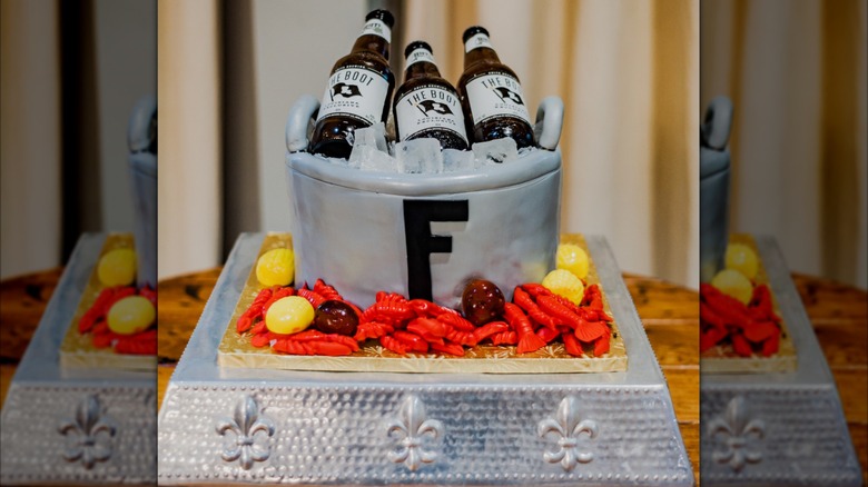 Groom's cake shaped like crawfish boil and bucket of beer