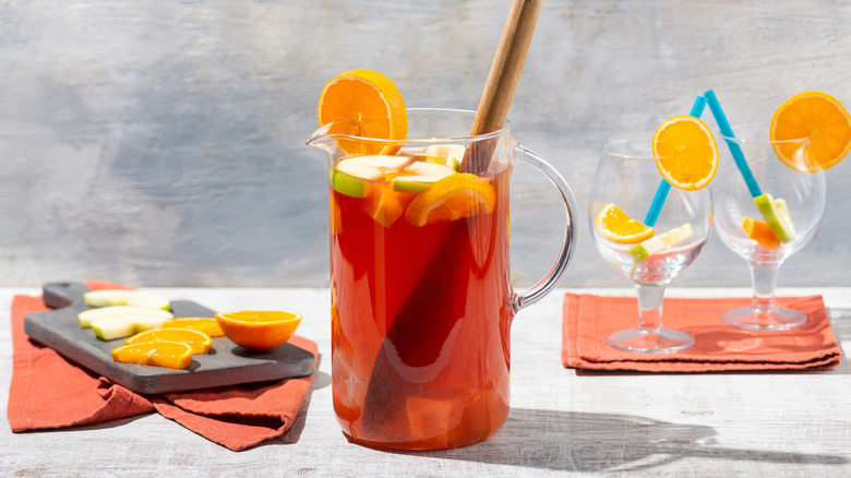 Pitcher of red sangria and empty glasses