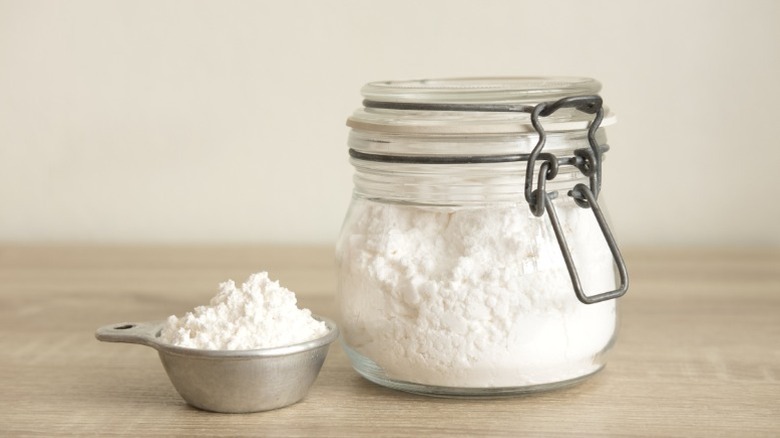 Flour in a glass jar and in a small bowl.