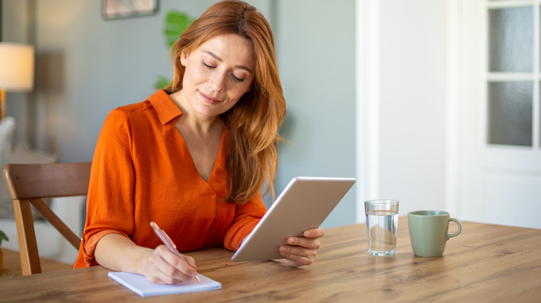 Woman writing recipe