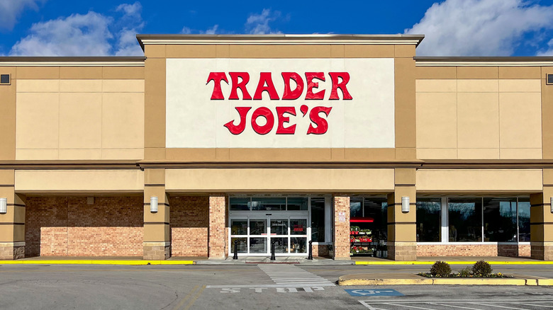 A Trader Joe's storefront against a blue sky on a sunny day