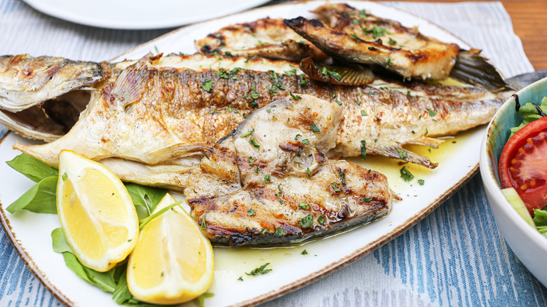 Grilled whole fish with fresh lemon, olive oil, and herbs