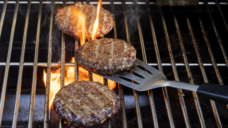 Burger patties cooking on grill