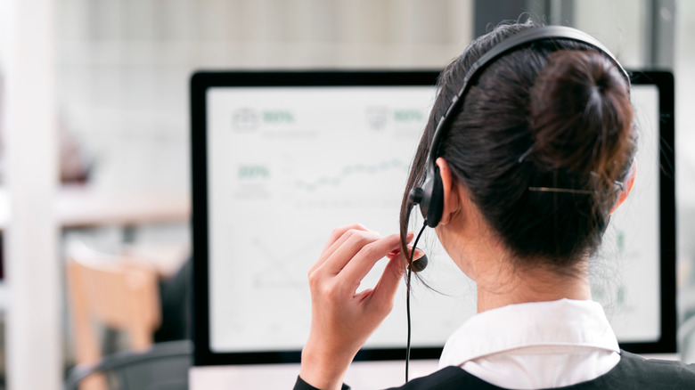 A customer service representative speaking into a headset.
