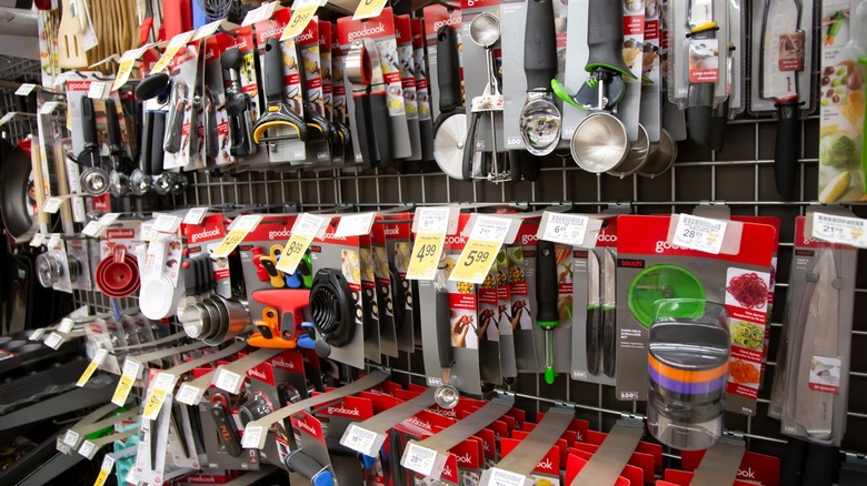 Various kitchen tools on rack at grocery store
