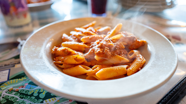 Pasta with meat sauce served in a white bowl