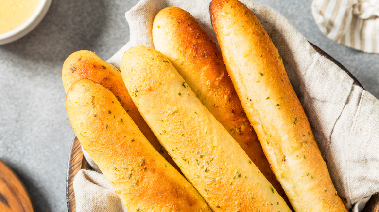Breadsticks in a lined basket