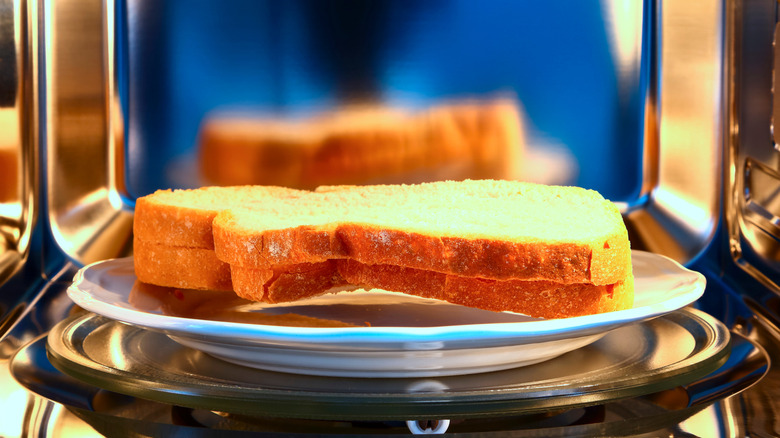 Sliced bread on a plate in a microwave