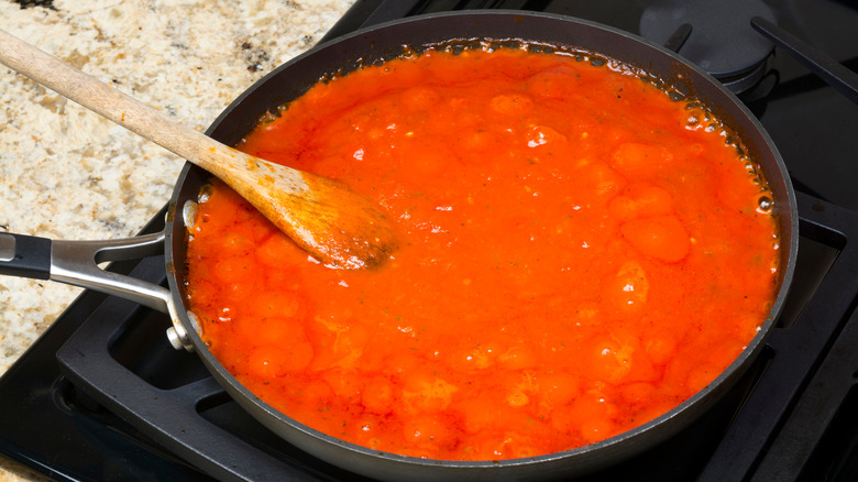 Marinara sauce cooking in a pan on the stovetop