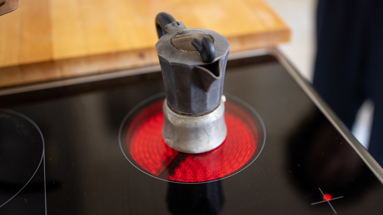 Moka coffee pot heating on electric stove