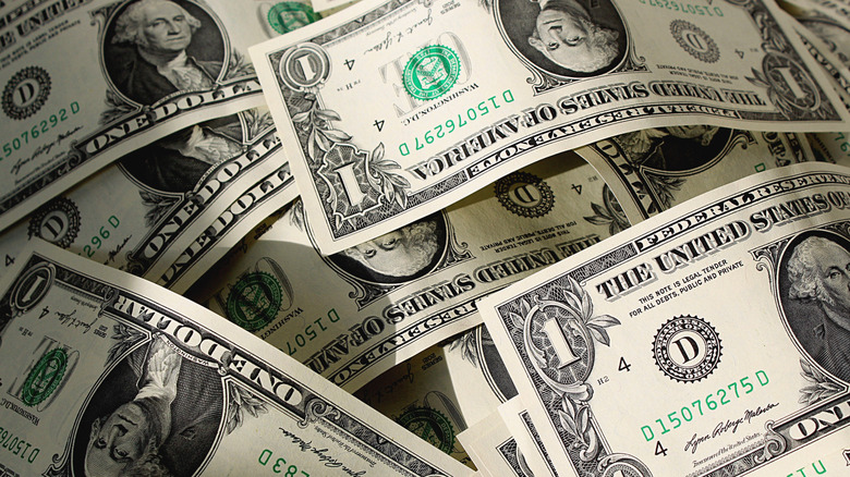 A pile of one dollar bills