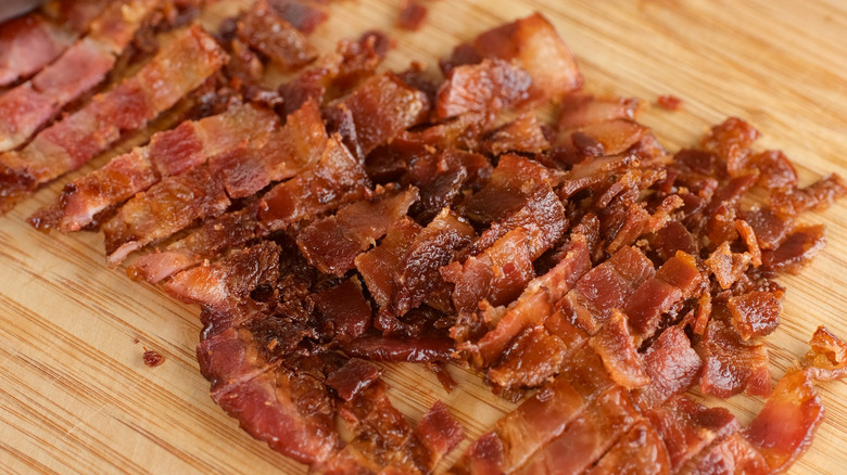 Candied bacon chopped on a board
