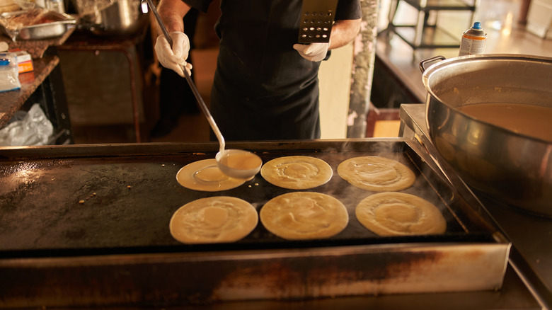 Making pancakes in restaurant kitchen