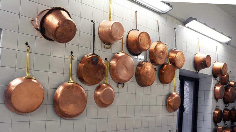 Copper pans hanging on a wall