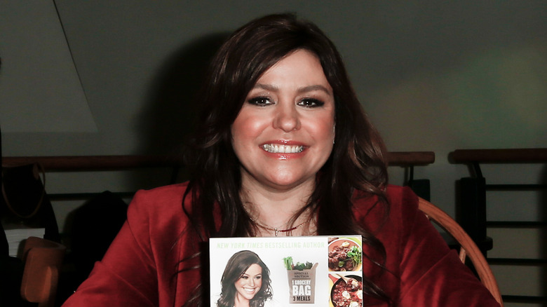 Chef Rachael Ray poses for the camera while holding her new book 