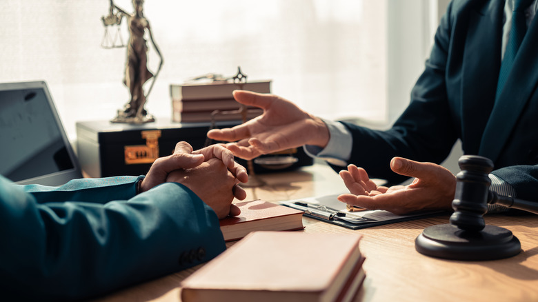 Two lawyers engaged in a discussion at a desk