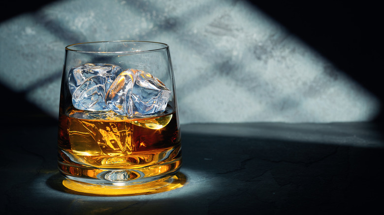 A glass of whiskey with clear ice cubes