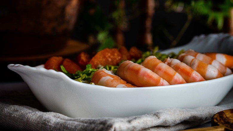 Poached shrimp in white glass bowl