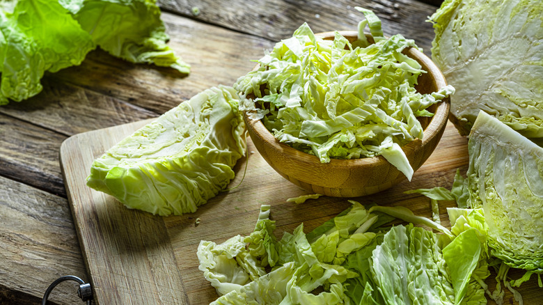 Chopped up cabbage in bowl and on board