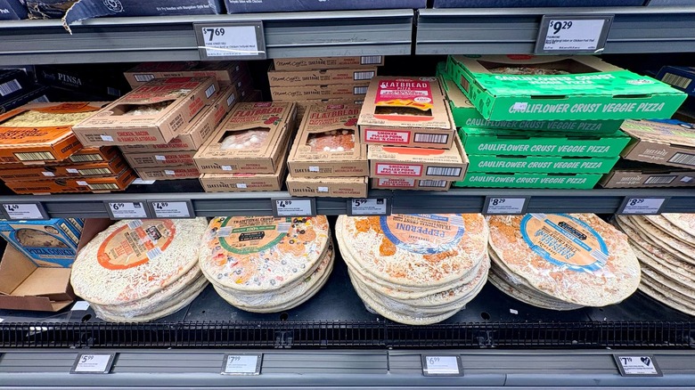 A view of pizzas sold at Aldi stacked on top of each other.