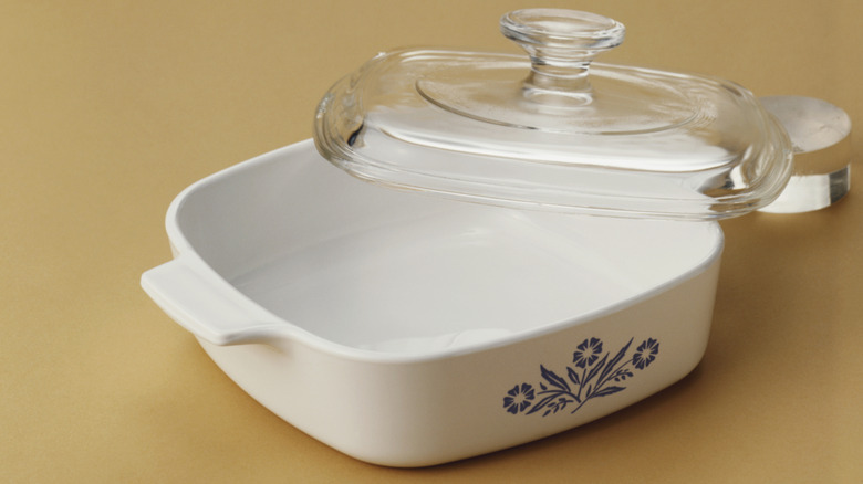 Vintage Pyrex dish that's white with blue flowers and a glass lid