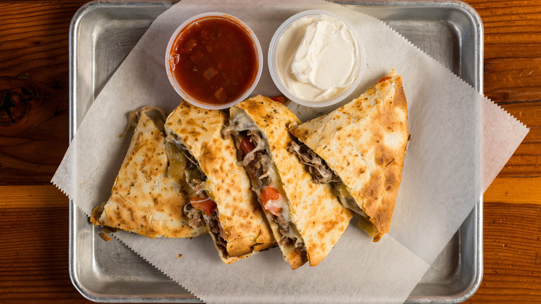 Steak quesadilla with salsa and sour cream on the side