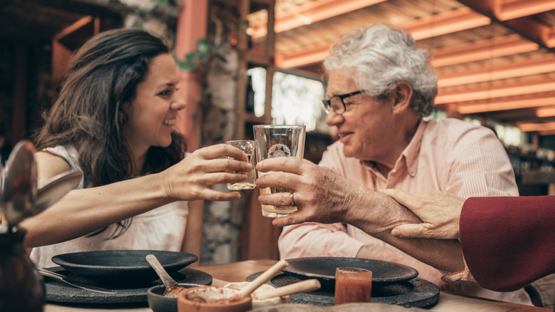 A family clinking glasses at a Mexican restaurant