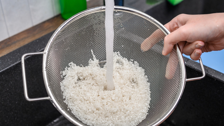 Rinsing rice in fine mesh strainer