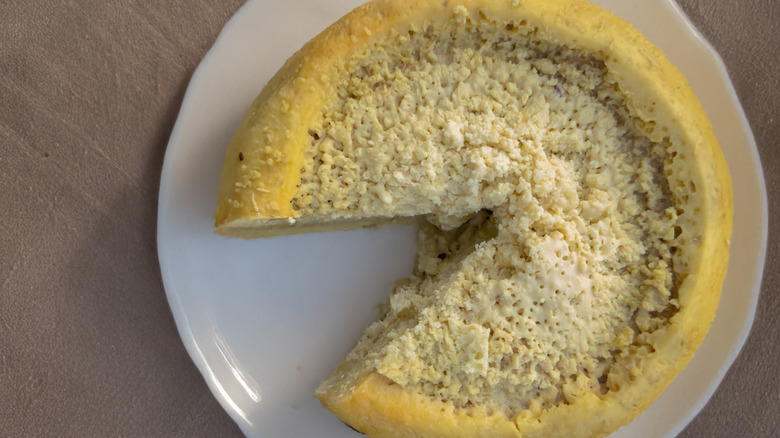 Casu marzu cheese with a slice taken out