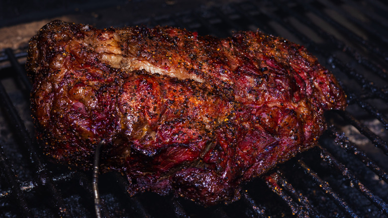 A smoked chuck roast sitting on a hot grill
