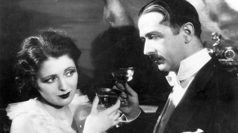 A man and woman drink alcohol in the 1920s