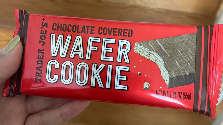 A woman's hand holds Trader Joe's Chocolate Covered Wafer Cookie