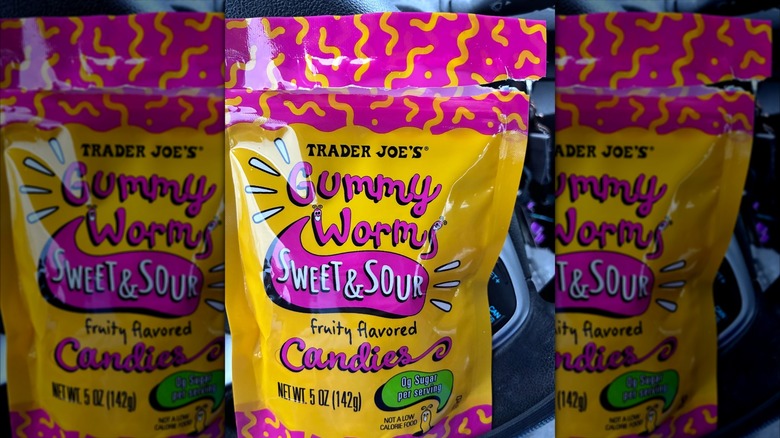 An opened bag of zero-sugar gummy worms from Trader Joe's in a car
