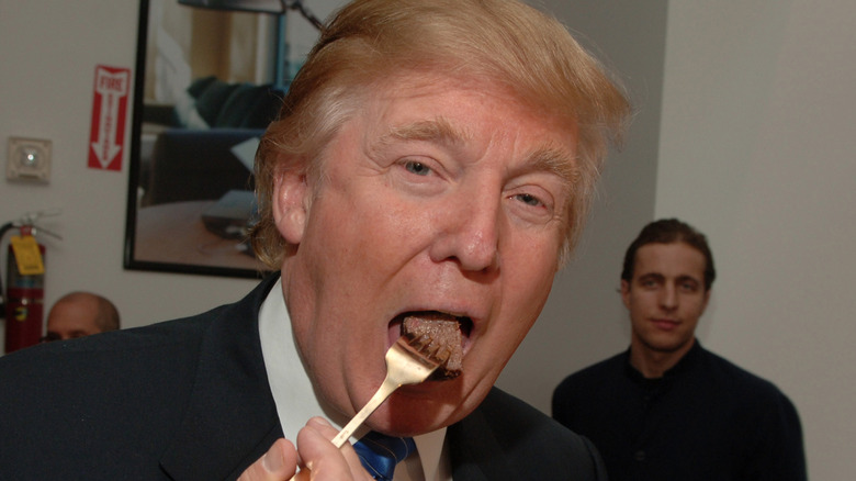 Donald Trump bites into a piece of steak
