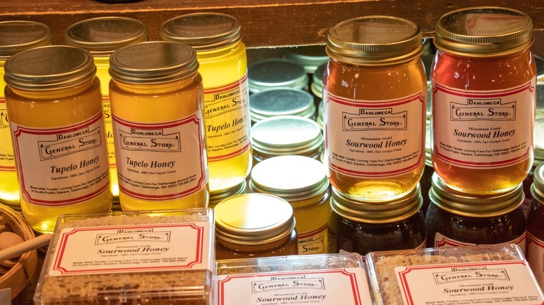 Jars of tupelo and sourwood honey on sale