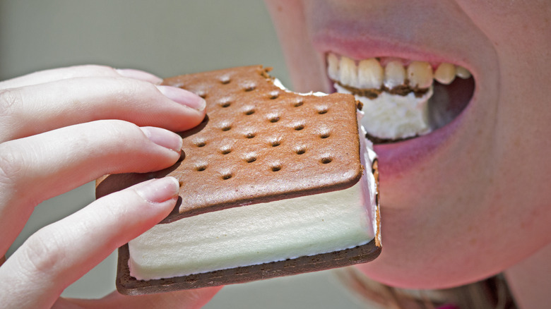 Person biting into perfectly shaped ice cream sandwich