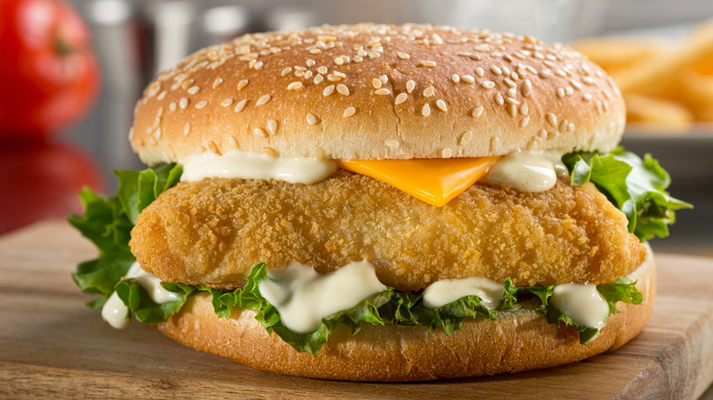 A fish sandwich sitting on a counter.