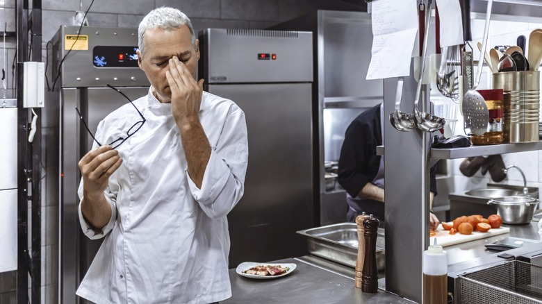 Distressed chef in commercial kitchen