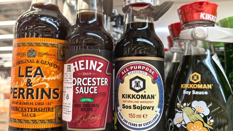 A bottle of Heinz Worcestershire sauce on a shelf next to other condiments.