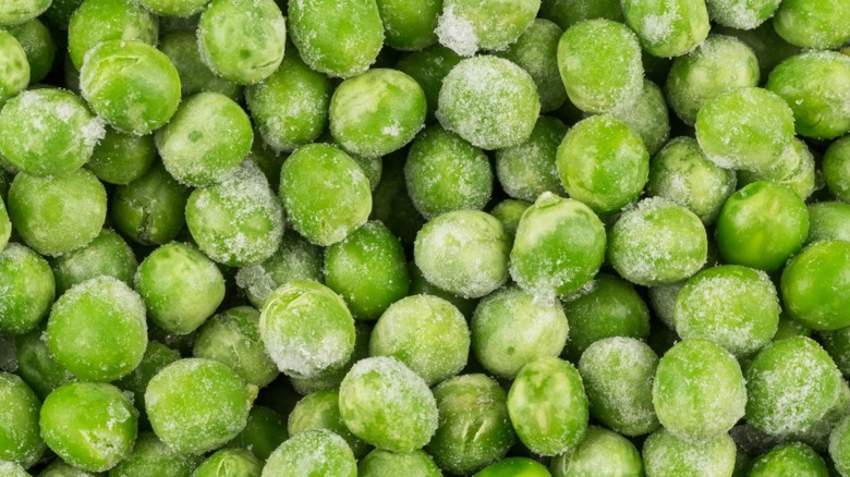 A close up of frozen peas with frost on them