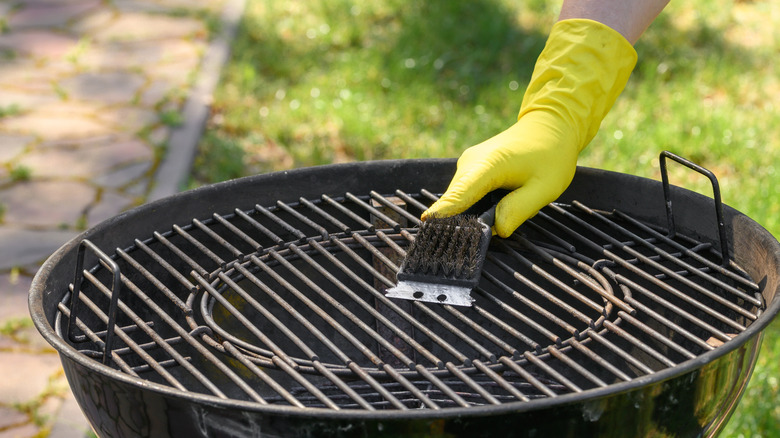 a grill with a wire brush on top