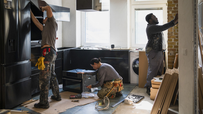 Workers remodeling a kitchen.