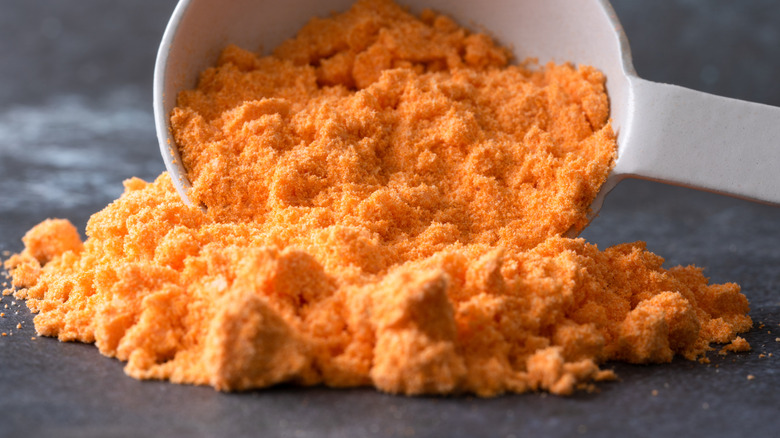 Cheese powder in measuring cup