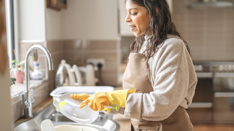 Woman washing dishes