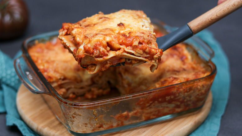 Removing a portion of lasagna from a baking dish with a spatula