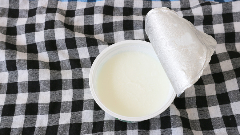 A seal on a sour cream container